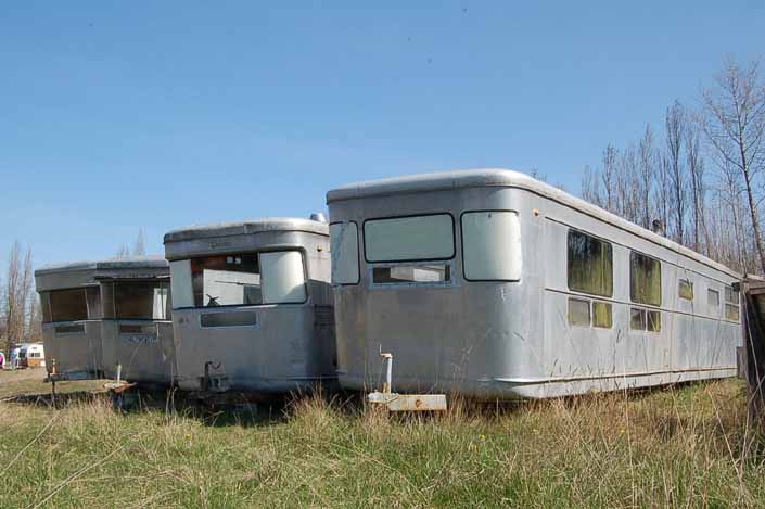 Vintage trailer Storage Yard has row of Spartan Manor vintage trailers ready for restoration
