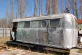 Close-up view of a rare Palace trailer found in a vintage trailer junkyard