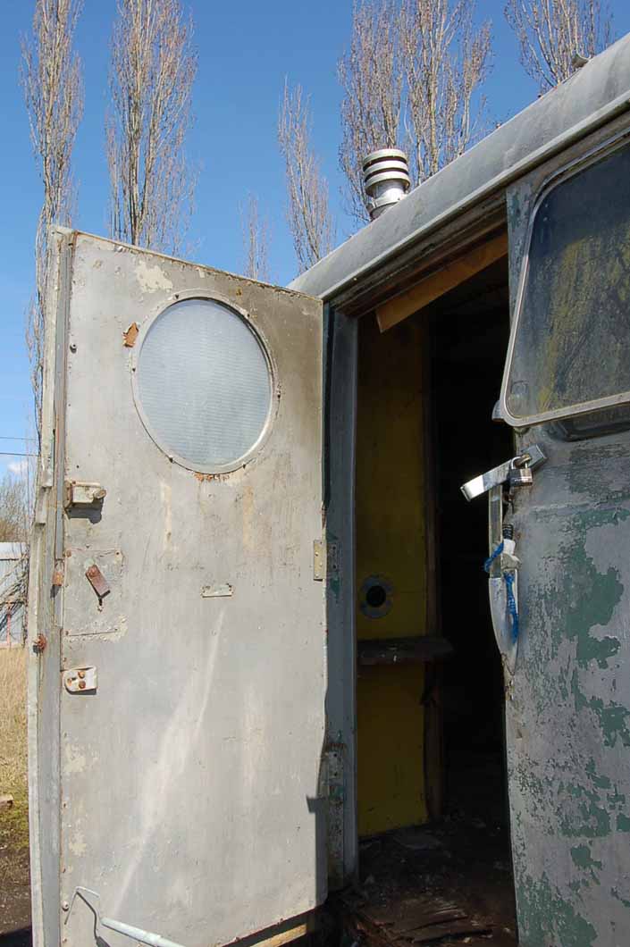 Cool port hole window and acrylic plexi grab handle on a Palace trailer, in a vintage trailer Storage-Yard