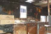 Photo shows extensive interior fire damage to a Shasta trailer found in a vintage trailer storage yard