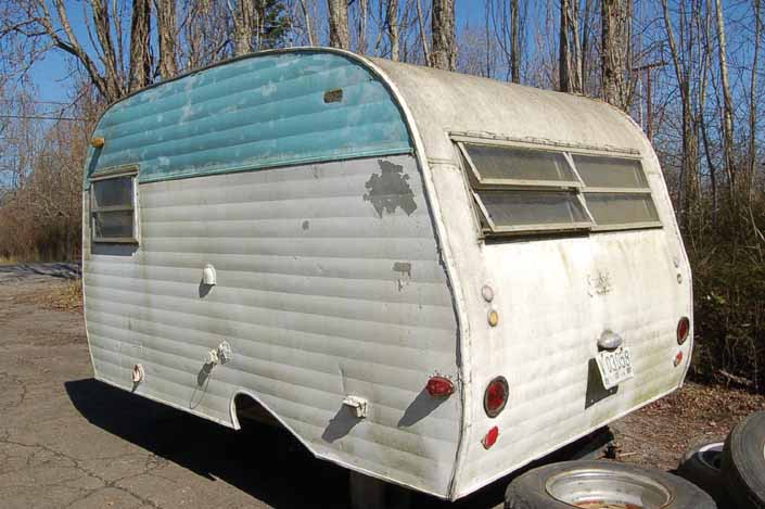 Vintage trailer storage yard has a vintage Serro-Scotty trailer, ready for restoration