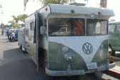 truck-based camper is an old trailer mated to a vintage VW bus body, skillfully modified to blend VW nose into the front of the camper