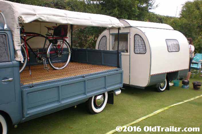 This vintage towing rig is a vintage volkswagen single cab pickup truck pulling a vintage trailer